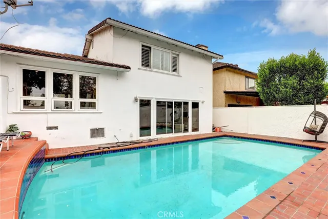 a view of a white house with a big yard and a large tree