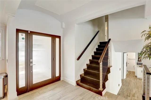 a view of entryway with wooden floor and windows