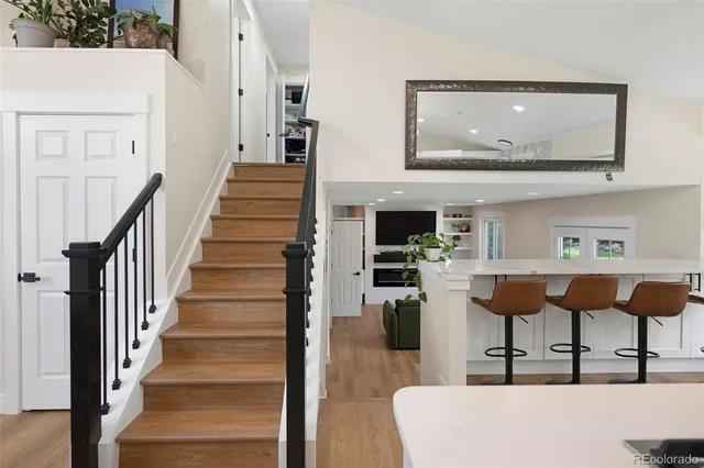 a view of entryway and hall with wooden floor