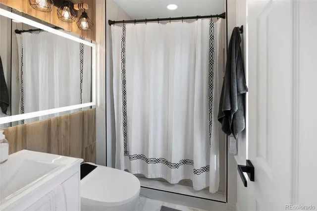 a bathroom with a shower curtain and a sink