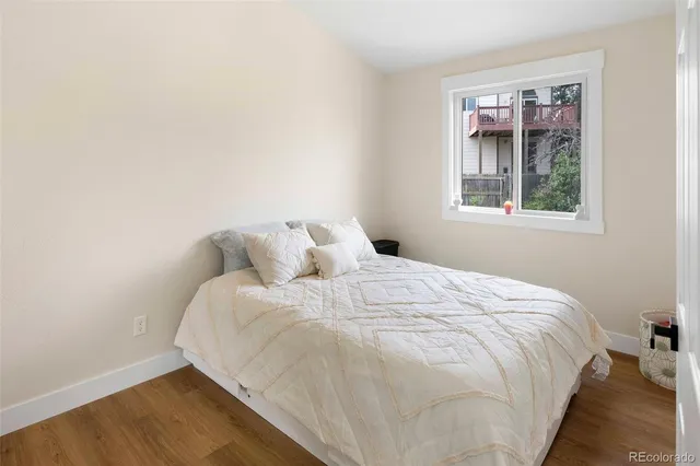 a large bed sitting in a bedroom next to a window