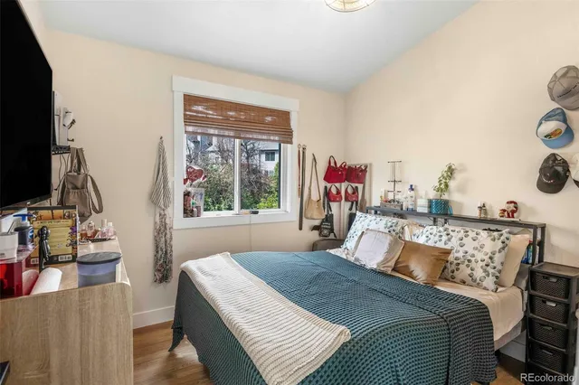 a bedroom with a bed and a large window