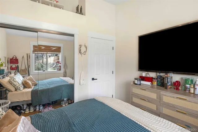 a bedroom with a bed and a flat screen tv