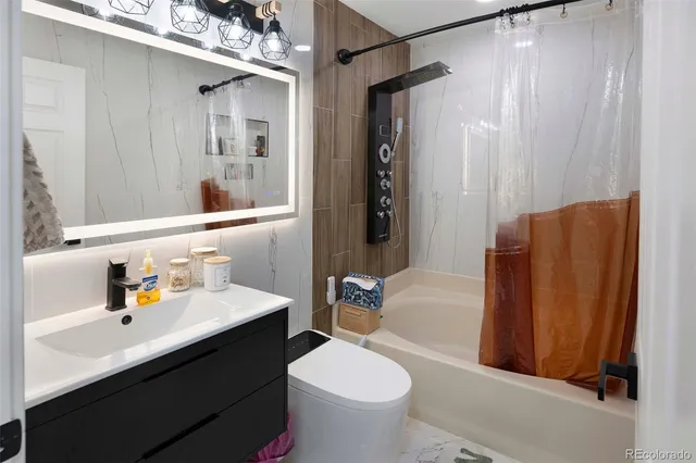 a bathroom with a sink toilet and shower