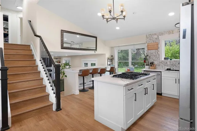 a kitchen with stove and wooden floor