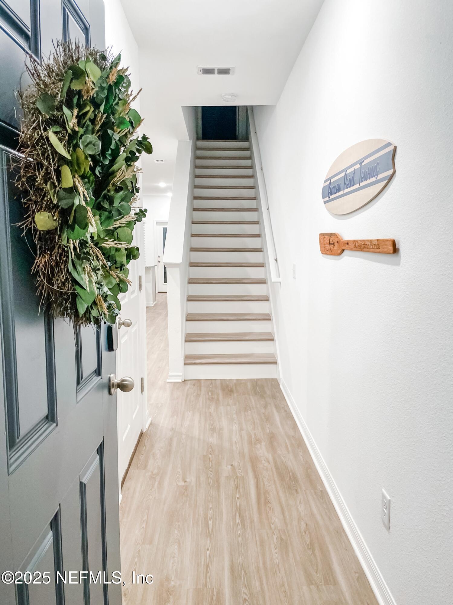 95 Zaragoza Drive St. Augustine, FL 32086 - Photo 2 of 18 a view of a room with wooden floor and a potted plant