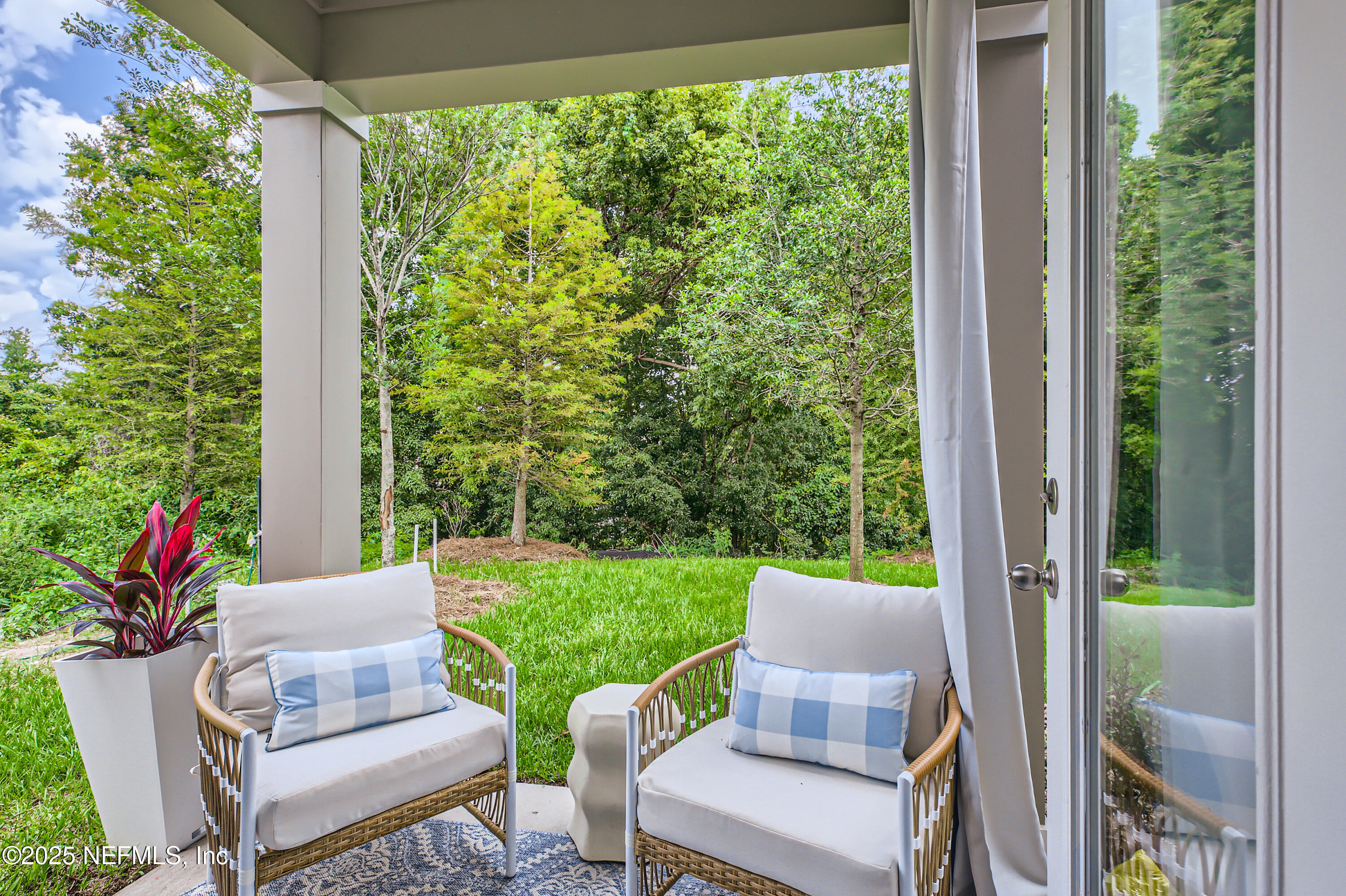 95 Zaragoza Drive St. Augustine, FL 32086 - Photo 8 of 18 a view of a patio with table and chairs and potted plants