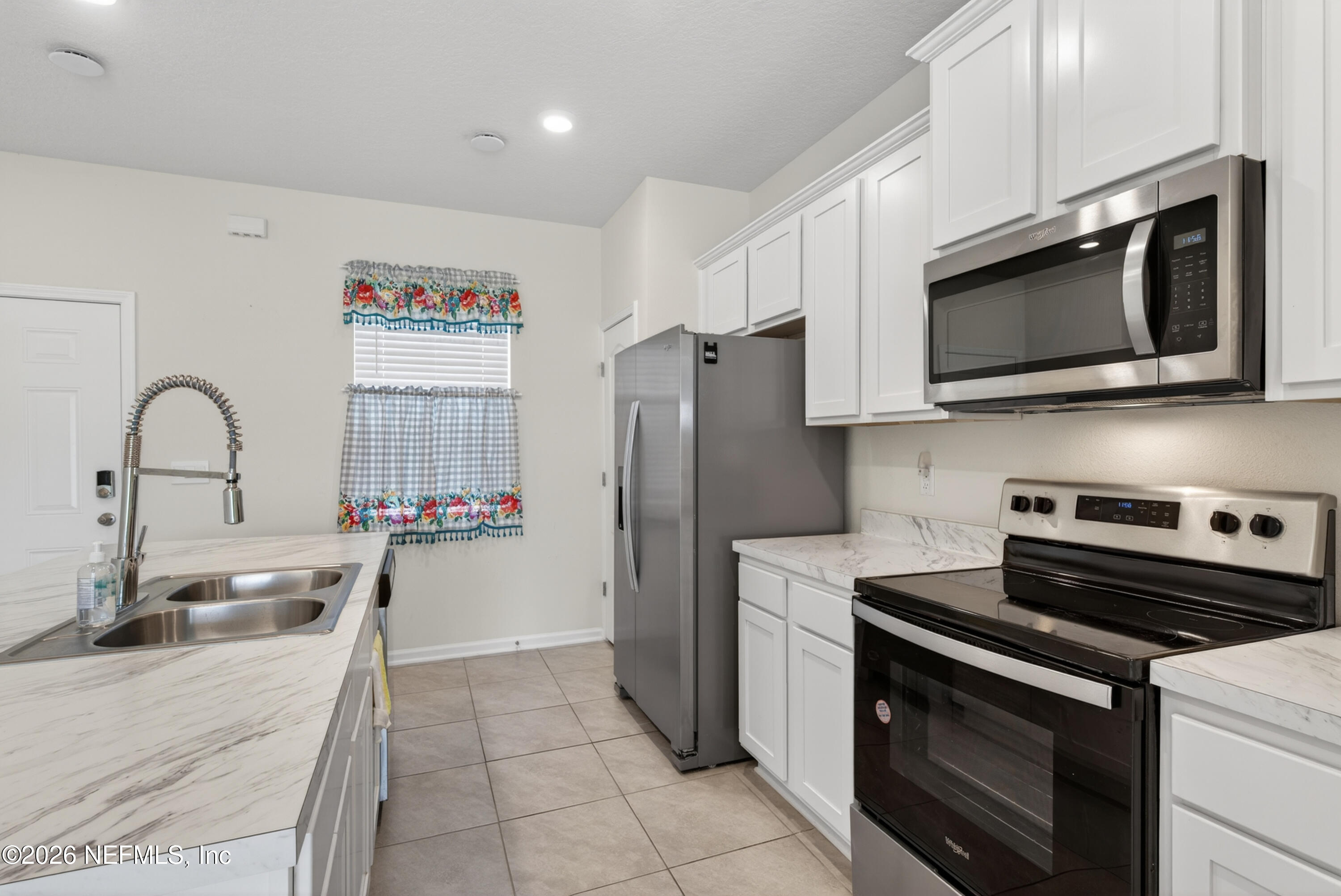 8210 Larose Road Jacksonville, FL 32211 - Photo 8 of 38 a kitchen with granite countertop a stove and a microwave