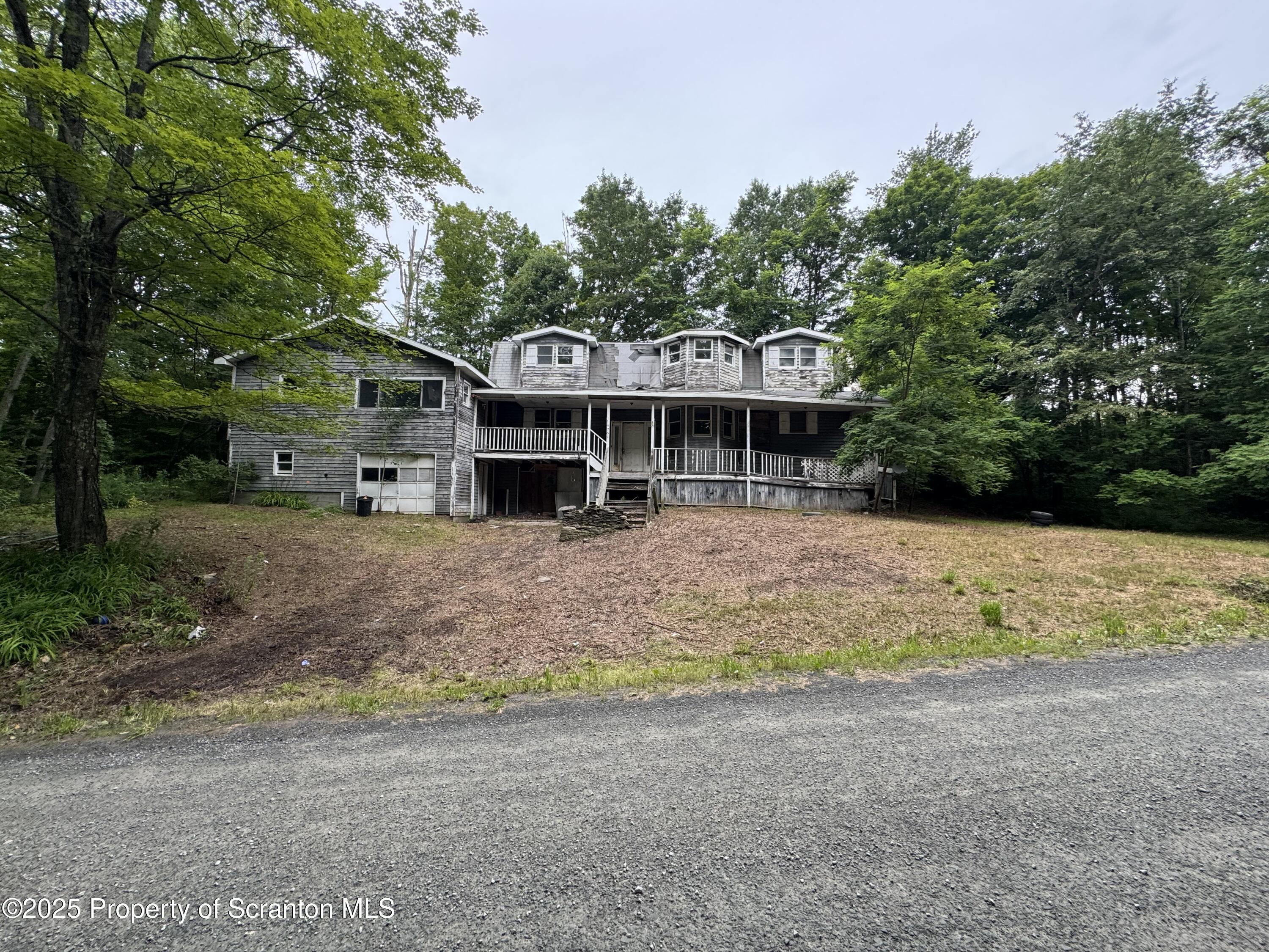 761 Green Road Montrose, PA 18801 - Photo 1 of 11 a front view of a house with a yard and potted plants
