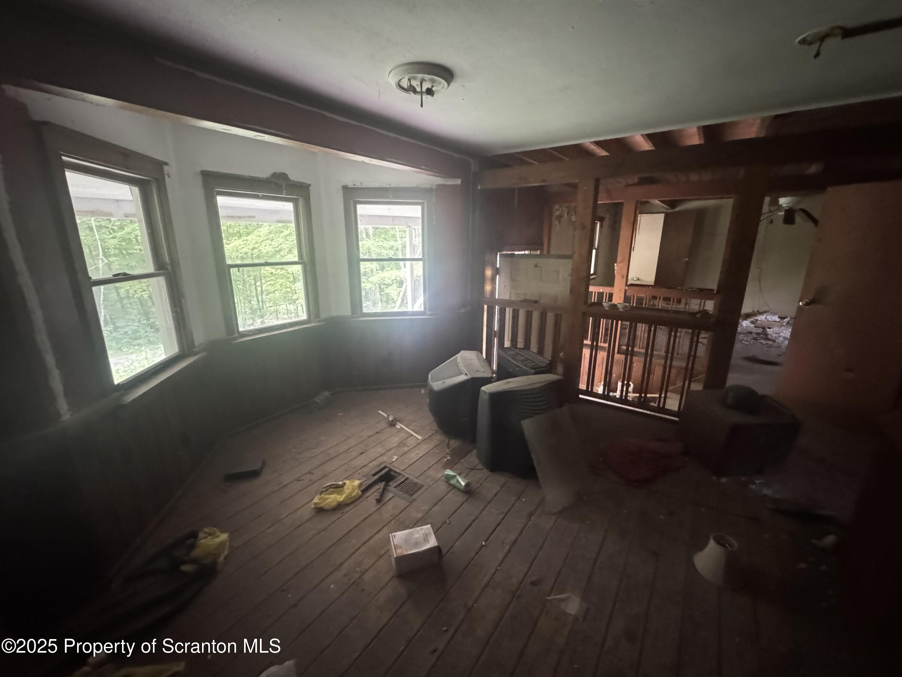 761 Green Road Montrose, PA 18801 - Photo 8 of 11 a living room with furniture floor to ceiling window and wooden floor