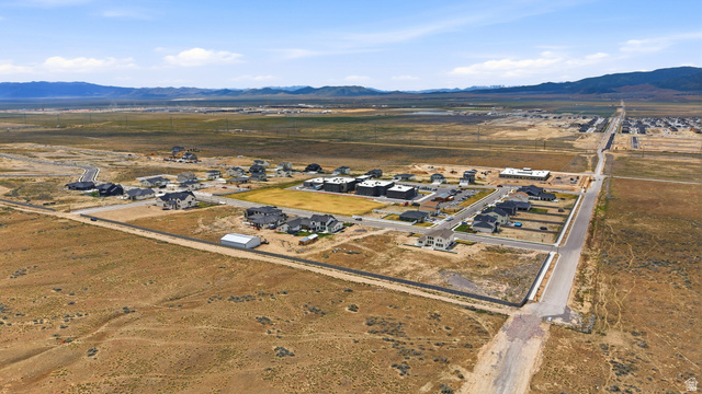 2930 Jojo Road, Unit 110 Eagle Mountain, UT 84005 - Photo 13 of 22 Aerial view of property's location with nearby suburban area, mountains, and rural landscape