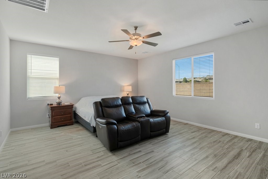 4191 Velvet View Street Las Vegas, NV 89129 - Photo 17 of 44 Bedroom with light wood-style floors and ceiling fan