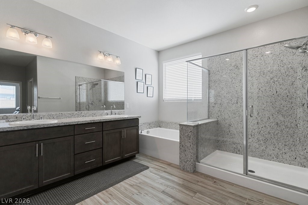 4191 Velvet View Street Las Vegas, NV 89129 - Photo 21 of 44 Full bathroom with double vanity, a stall shower, a bath, and light wood finished floors