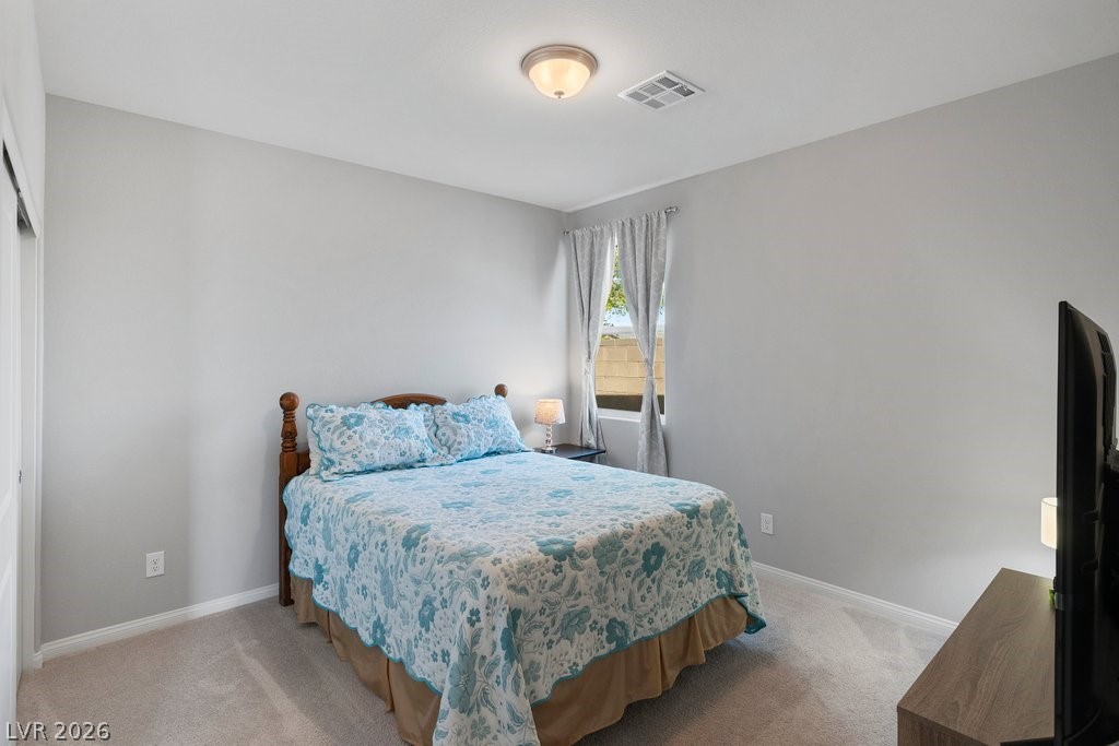 4191 Velvet View Street Las Vegas, NV 89129 - Photo 22 of 44 Bedroom featuring baseboards and light colored carpet