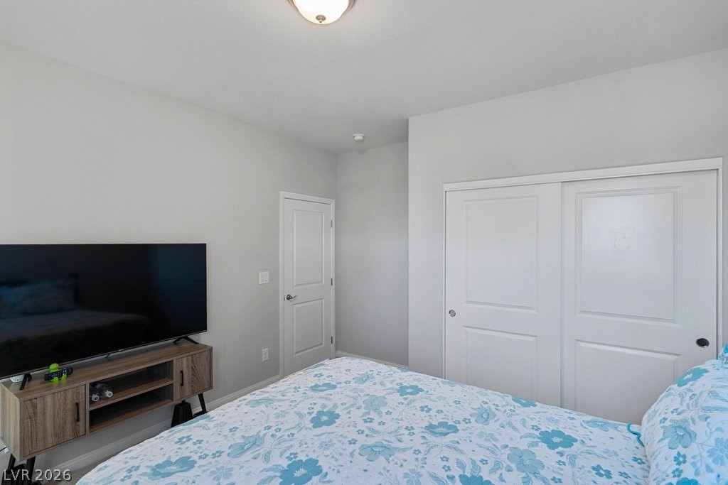 4191 Velvet View Street Las Vegas, NV 89129 - Photo 23 of 44 Bedroom with a closet and baseboards