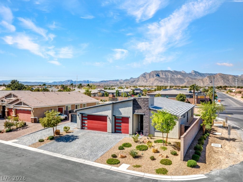 4191 Velvet View Street Las Vegas, NV 89129 - Photo 33 of 44 Contemporary house with an attached garage, stucco siding, decorative driveway, and a mountain view