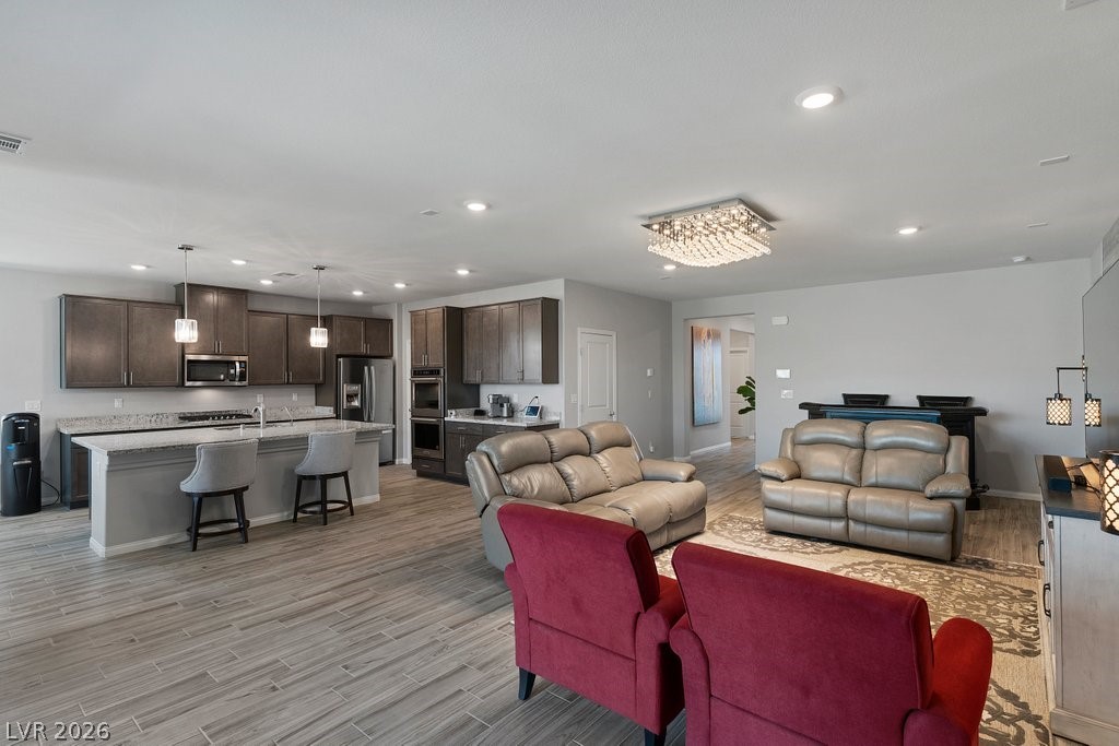 4191 Velvet View Street Las Vegas, NV 89129 - Photo 4 of 44 Living area with light wood-style flooring and recessed lighting