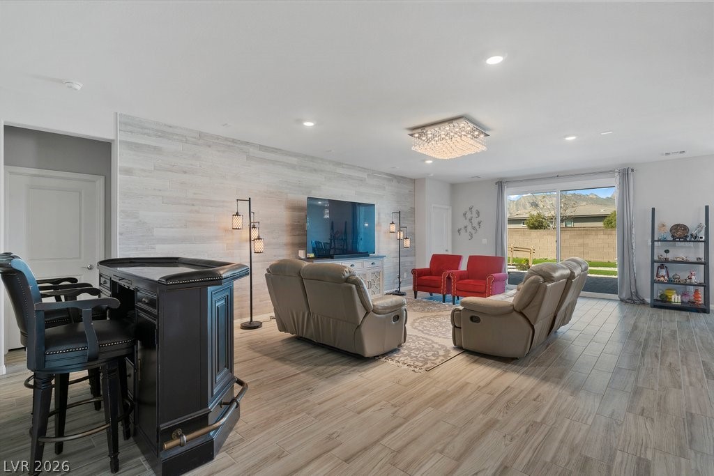 4191 Velvet View Street Las Vegas, NV 89129 - Photo 5 of 44 Living area with light wood-style flooring, an accent wall, and recessed lighting