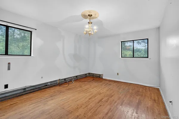 a view of room with hardwood floor and window