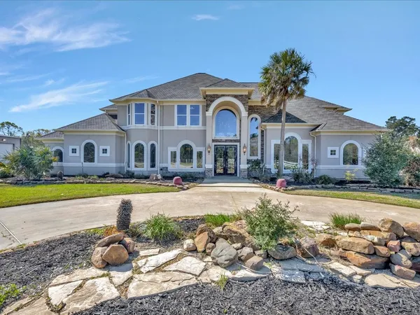 a front view of a house with swimming pool having outdoor seating