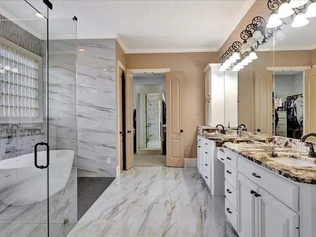 a spacious bathroom with a shower sink and mirror