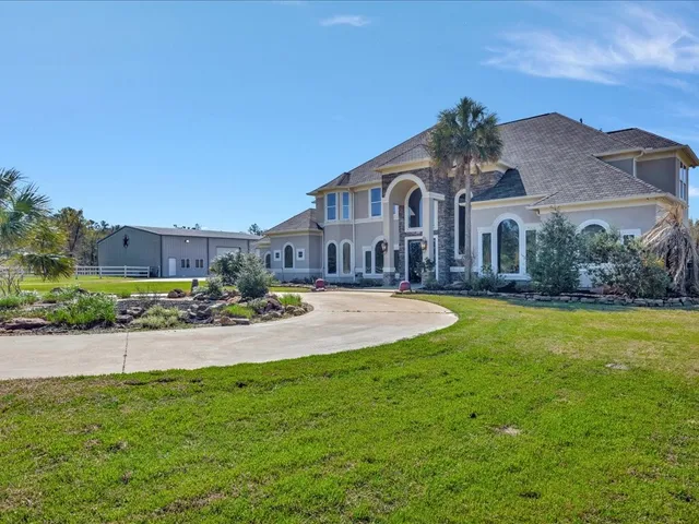 a front view of a house with a garden and yard