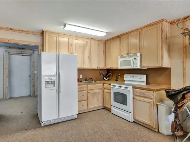a kitchen with a white cabinets and white appliances