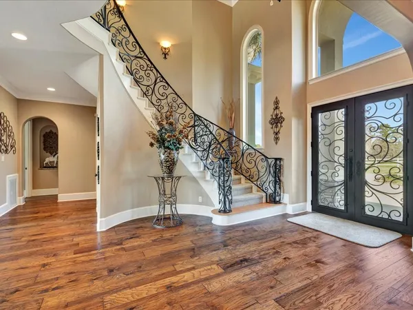 a view of entryway and hall with wooden floor
