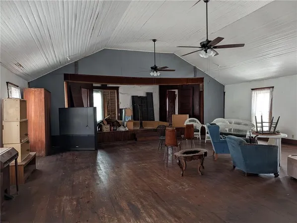 a living room with furniture a ceiling fan and a window