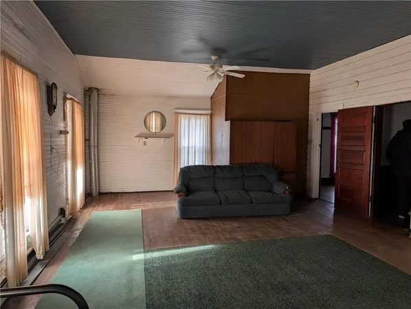 a living room with a couch and a refrigerator