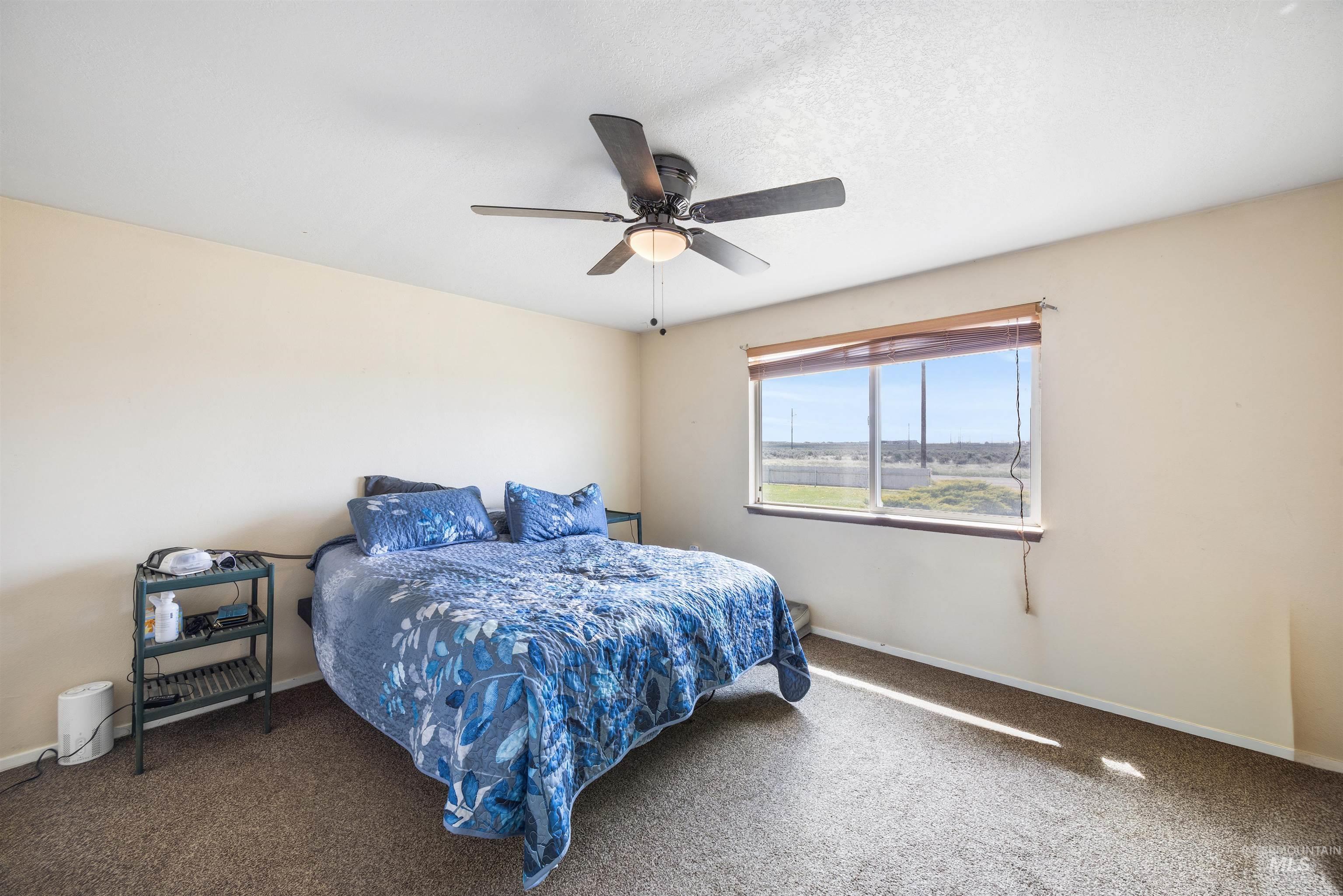 3044 Northeast Reservoir Road Mountain Home, ID 83647 - Photo 16 of 34 Bright room with a large window and horizontal blinds