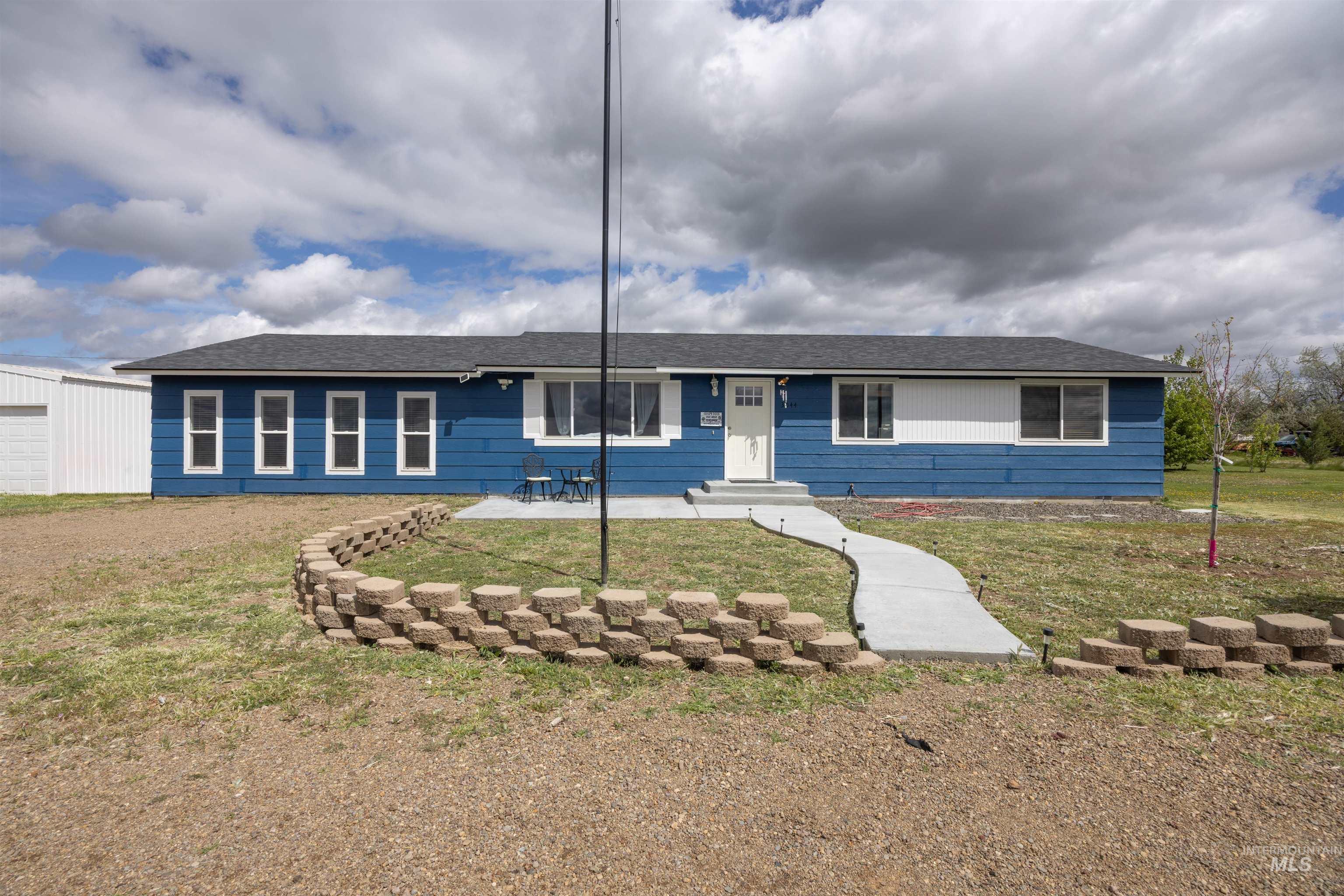 3044 Northeast Reservoir Road Mountain Home, ID 83647 - Photo 2 of 34 Blue exterior siding with white trim