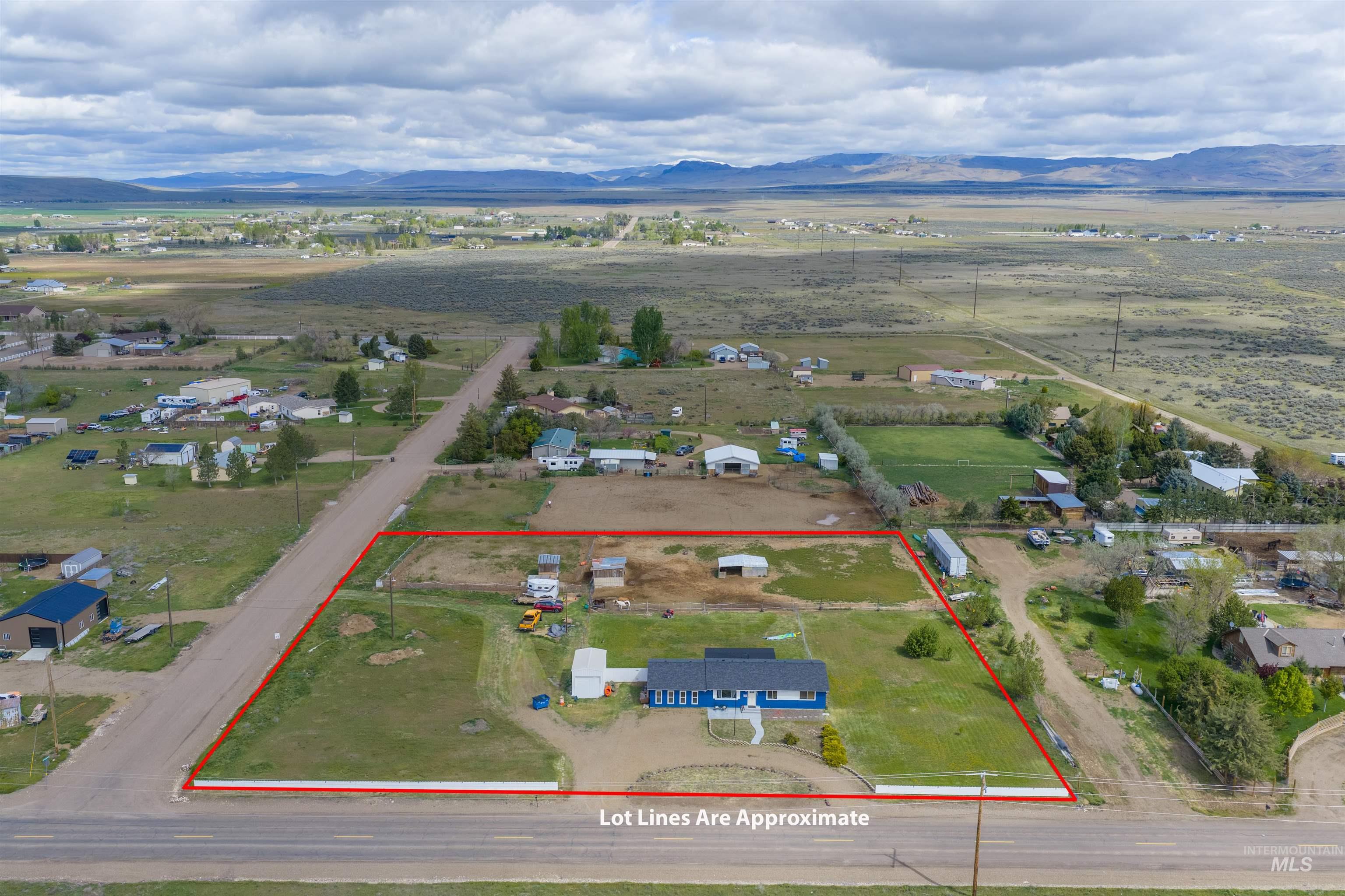 3044 Northeast Reservoir Road Mountain Home, ID 83647 - Photo 31 of 34 Aerial property overview showcasing a blue single-story residence with a dark roof