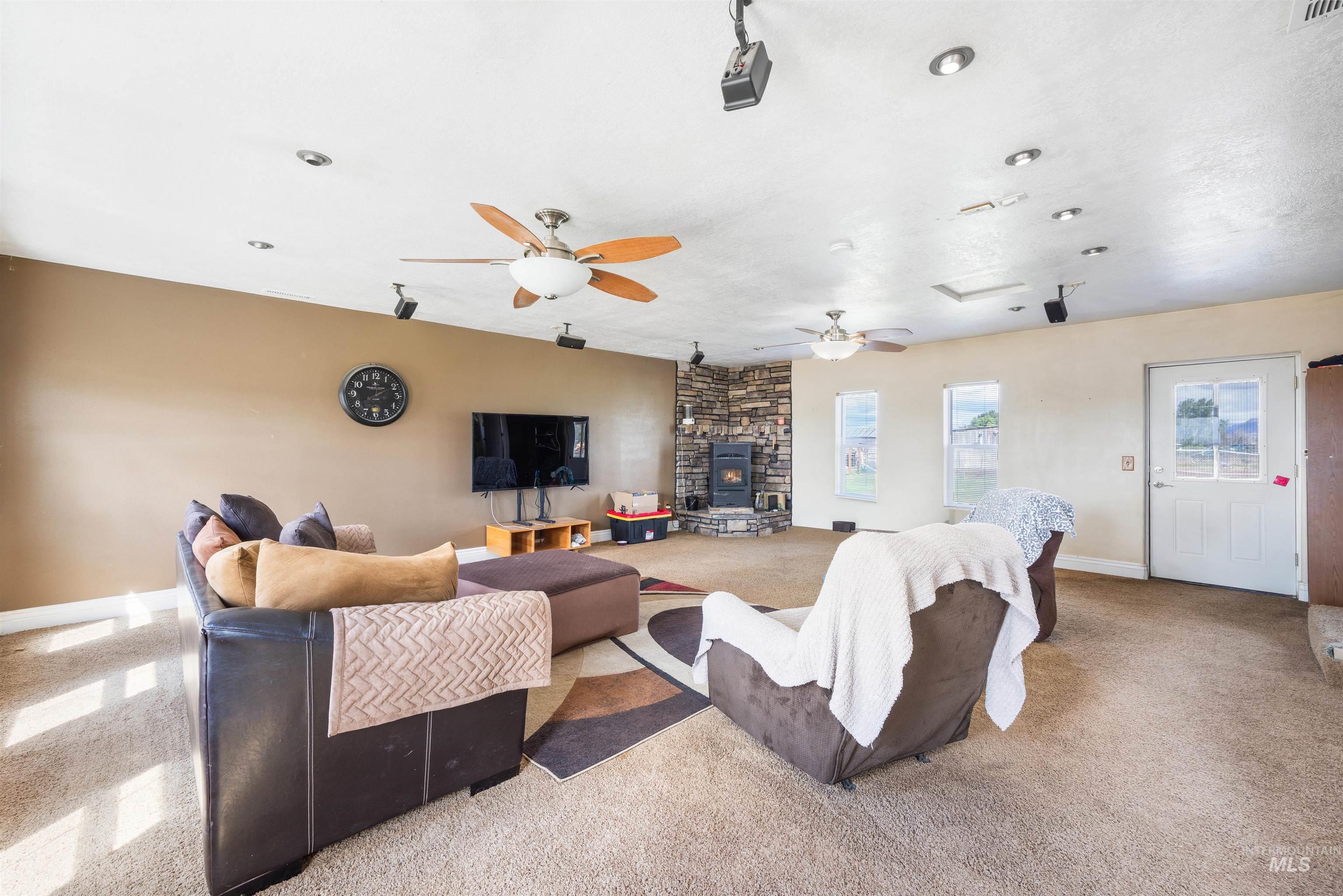 3044 Northeast Reservoir Road Mountain Home, ID 83647 - Photo 5 of 34 Spacious interior with neutral-toned walls, recessed lighting, and multiple ceiling fans