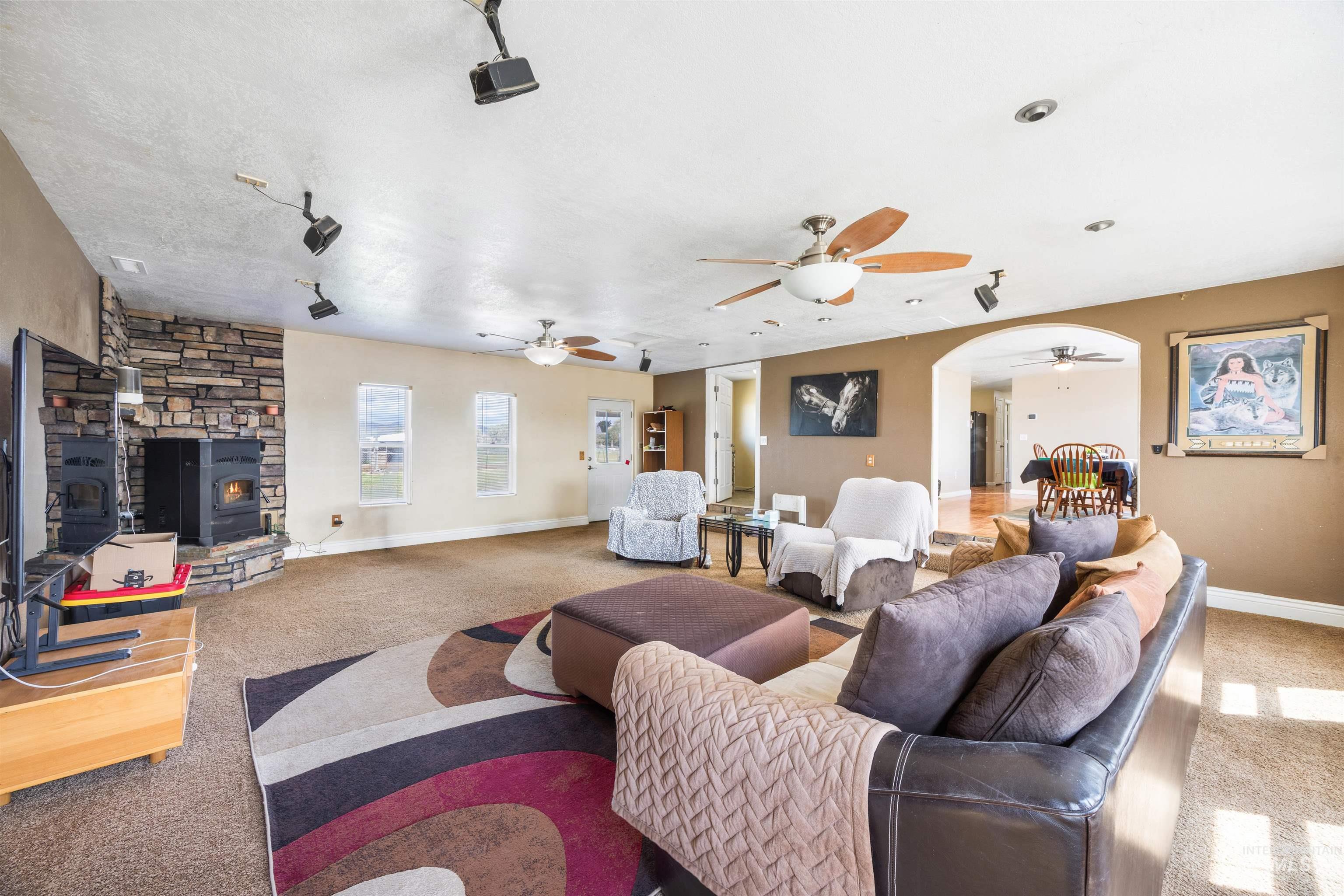 3044 Northeast Reservoir Road Mountain Home, ID 83647 - Photo 8 of 34 Spacious living area featuring a stone-clad fireplace surround with two hearths