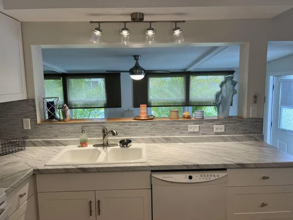 a bathroom with a granite countertop sink and a large mirror