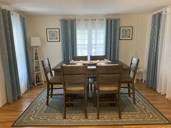 a dining room with furniture and window