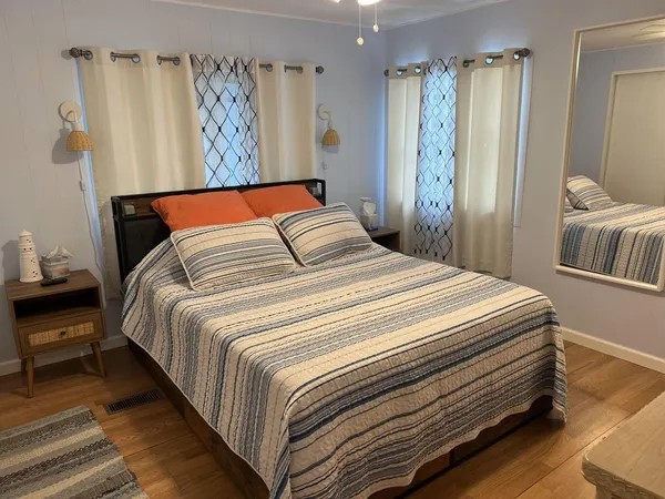 a bedroom with a bed and a painting on the wall
