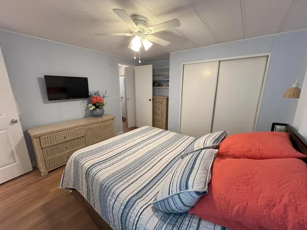 a bedroom with a bed and a flat screen tv