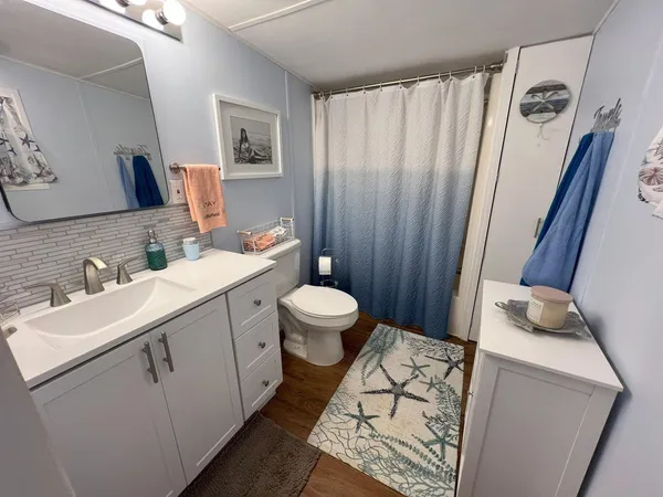 a bathroom with a sink toilet and shower