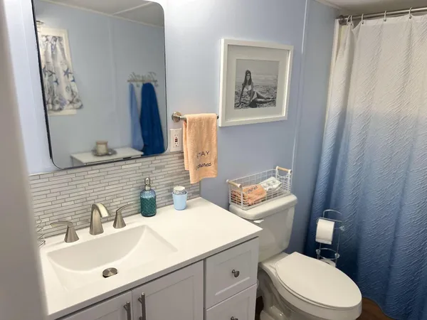 a bathroom with a sink mirror and toilet