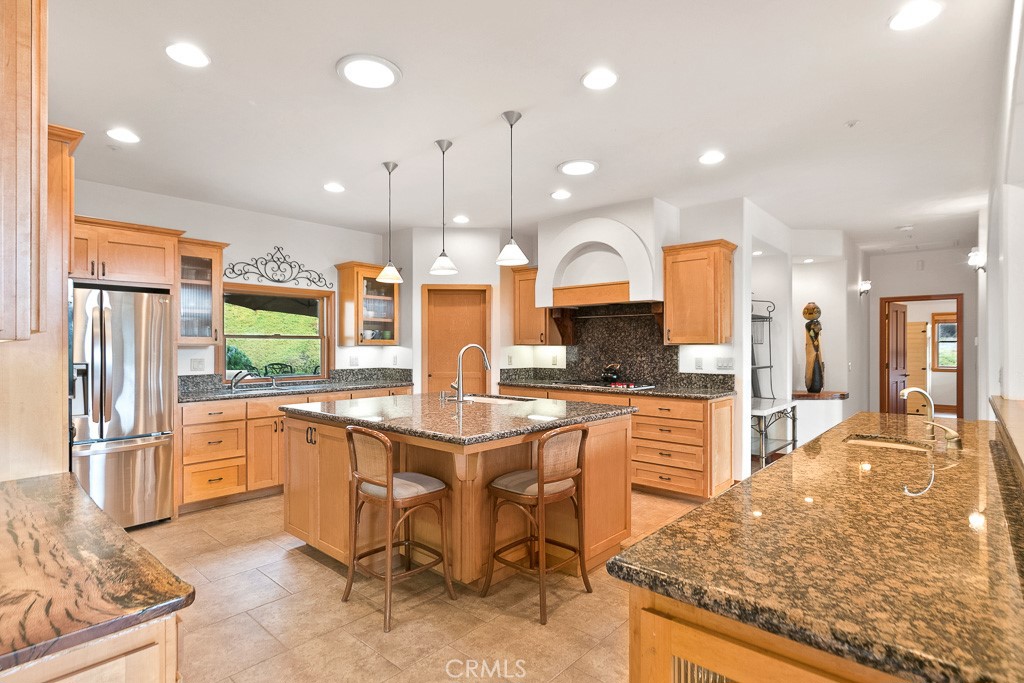 40635 De Luz Road Fallbrook, CA 92028 - Photo 27 of 75 a large kitchen with a table and chairs in it