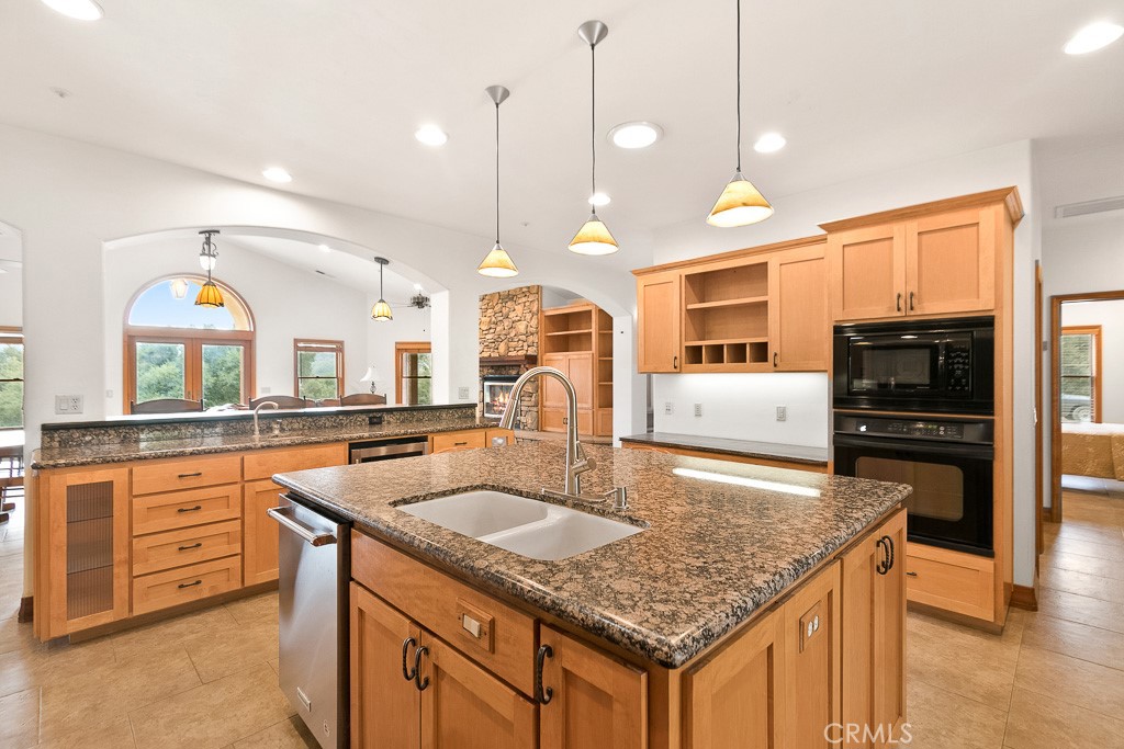 40635 De Luz Road Fallbrook, CA 92028 - Photo 29 of 75 a kitchen with stainless steel appliances granite countertop a kitchen island a stove and a sink