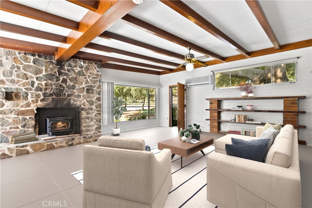 40635 De Luz Road Fallbrook, CA 92028 - Photo 42 of 75 a living room with furniture a fireplace and a floor to ceiling window