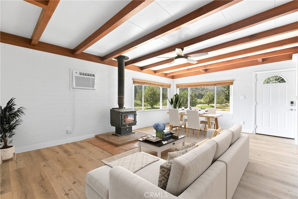40635 De Luz Road Fallbrook, CA 92028 - Photo 46 of 75 a living room with furniture large windows and wooden floor