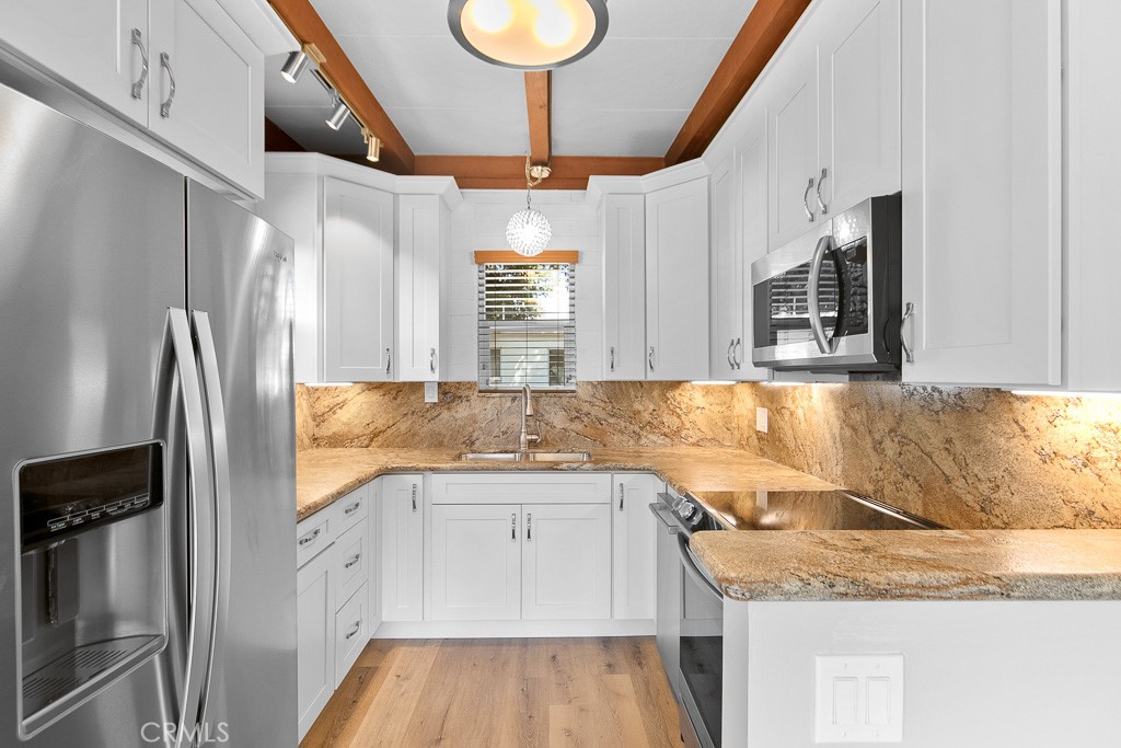 40635 De Luz Road Fallbrook, CA 92028 - Photo 47 of 75 a kitchen with a sink dishwasher a refrigerator and cabinets