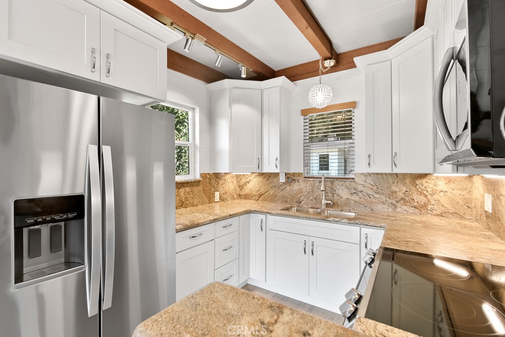 40635 De Luz Road Fallbrook, CA 92028 - Photo 49 of 75 a kitchen with a sink a refrigerator and cabinets