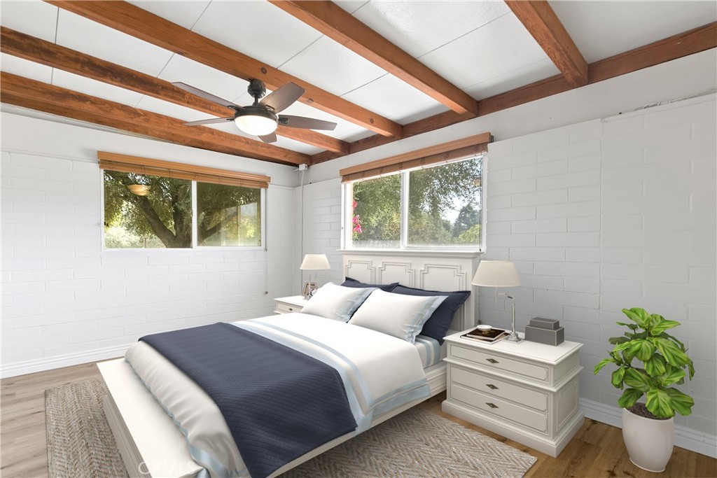 40635 De Luz Road Fallbrook, CA 92028 - Photo 50 of 75 a bedroom with a bed potted plant next to a window