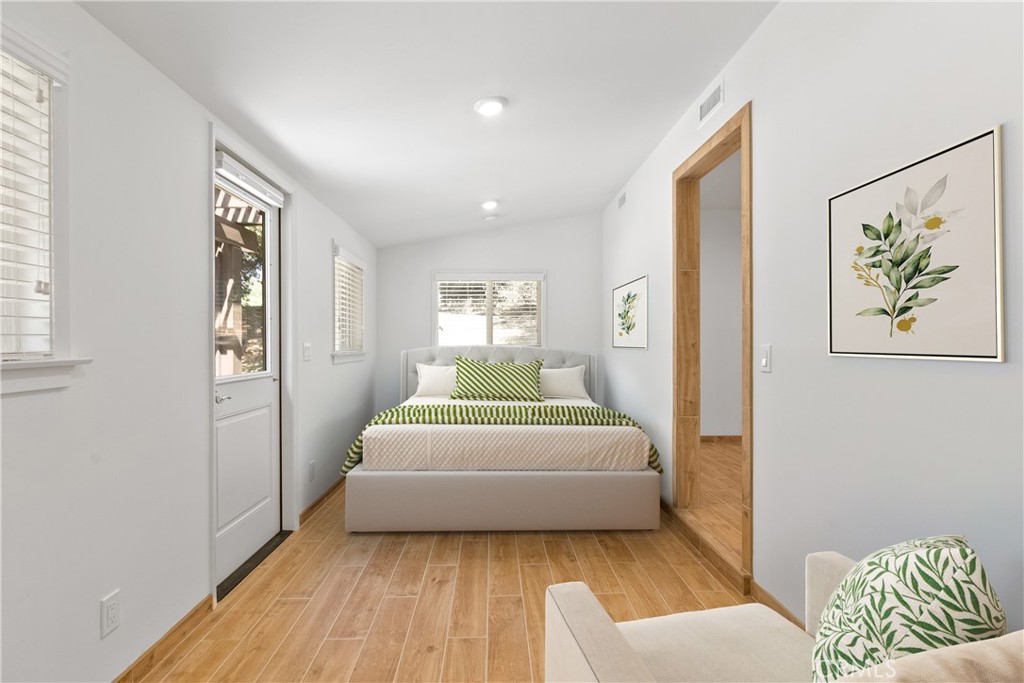 40635 De Luz Road Fallbrook, CA 92028 - Photo 62 of 75 a bedroom with a white bed and a couch