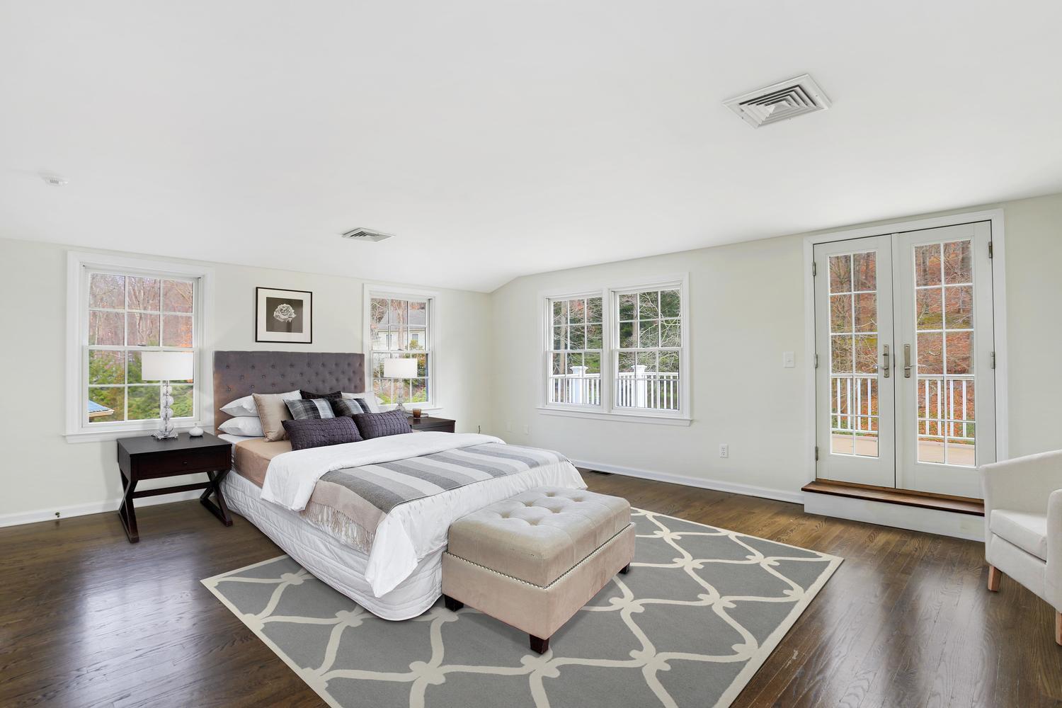 129 Hickok Road New Canaan, CT 06840 - Photo 16 of 32 a bedroom with a bed and wooden floor